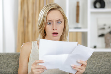 surprised woman gets letter with bad news