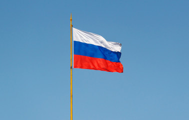 Fototapeta na wymiar Russian flag waving on the wind against blue sky