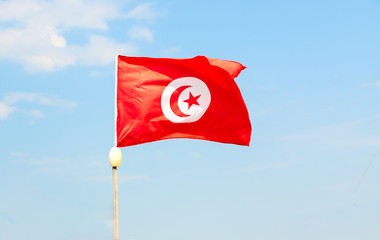 Tunisia flag photo on blue clear sky