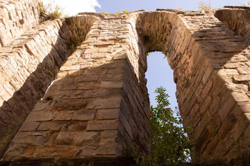 Narrow arch ruins with plants