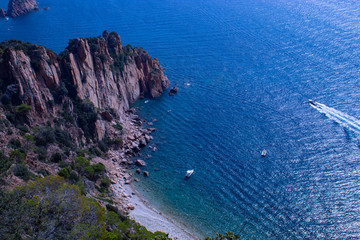 Tranquil bay with cliff and motorboat