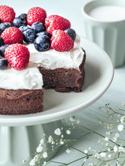 Cake made from chocolate and chestnut puree with fresh fruits on the top.