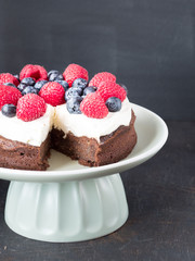 Cake made from chocolate and chestnut puree with fresh fruits on the top.
