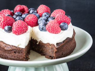 Cake made from chocolate and chestnut puree with fresh fruits on the top.