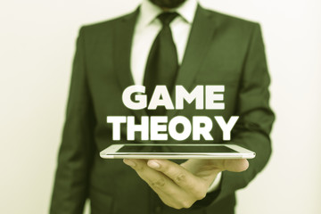 Writing note showing Game Theory. Business concept for branch of mathematics concerned with...