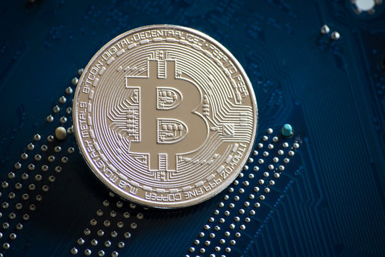 coin with bitcoin logo on computer parts. bussines of cryptocurrency background
