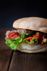 close up of kebab sandwich on wooden background