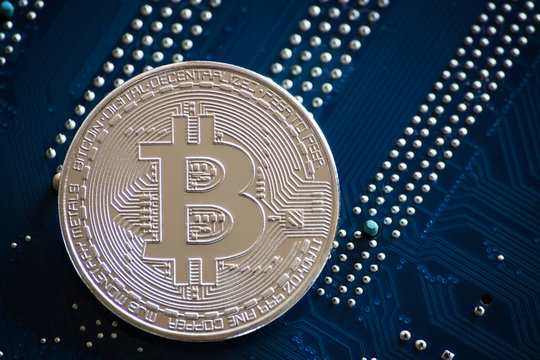 coin with bitcoin logo on computer parts. bussines of cryptocurrency background