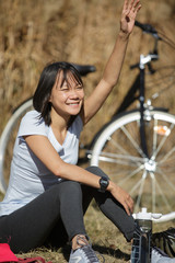 woman sitting outdoors waving to someone