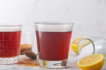 Homemade Isotonic Energy Drink and Ingredients. Glass With Red Liquid, Natural Sport Beverage