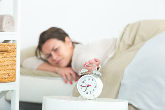 young beautiful woman hates waking up early in the morning
