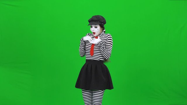 Mime girl found flower, sniffing, sortilege on it. Chroma key.