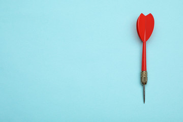 Red dart arrow on blue background, top view with space for text