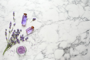 Flat lay composition with natural cosmetic products and lavender flowers on marble background. Space for text