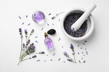 Composition with natural perfume and lavender flowers on white background, top view. Cosmetic product