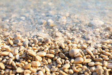 Closeup view of pebble beach on sunny day