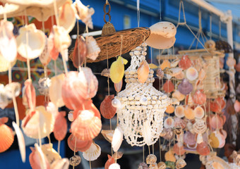 Wind chimes made of sea shells in outdoor souvenir shop