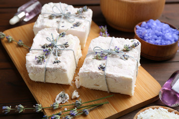 Fototapeta na wymiar Hand made soap bars with lavender flowers on wooden board
