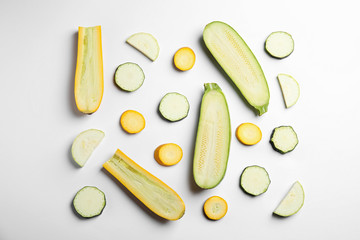 Fresh ripe cut zucchinis on white background, top view