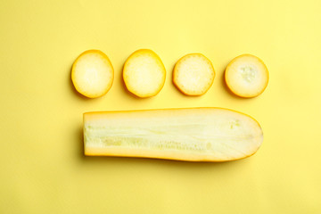 Fresh ripe cut zucchini on yellow background, flat lay