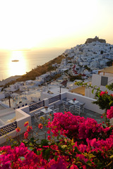 Fototapeta premium Picturesque castle of Astypalaia island as seen at sunrise through beautiful bougainvillea in blossom, Dodecanese, Greece