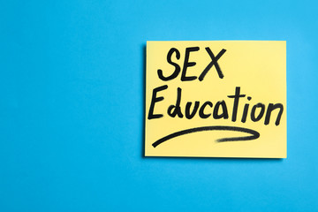 Note with phrase "SEX EDUCATION" on blue background, top view. Space for text