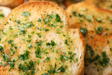 Slices of toasted bread with garlic and herbs as background, closeup