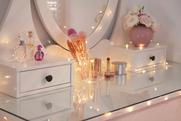 Elegant dressing table with lights in stylish room interior