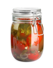 Pickled tomatoes in glass jar on white background