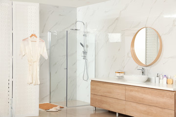 Modern bathroom interior with shower stall and folding screen