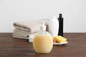 Toiletries and folded towels on wooden table