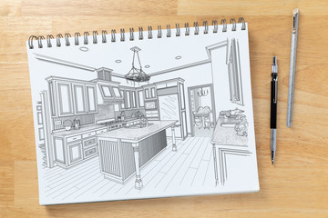 Sketch Pad on Desk Top with Drawing of Custom Kitchen Interior Next To Engineering Pencil and Ruler...