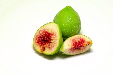 isolated well defined green figs with red and juicy pulp