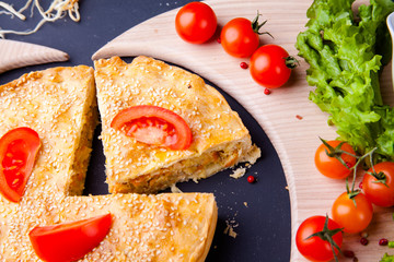 Fresh Traditional Australian meat mini pie on the wooden board on table background, closeup with copy space, top view, rustic style