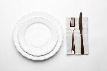 Elegant table setting on white background, top view