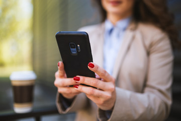 Businesswoman using phone,selective focus on phone