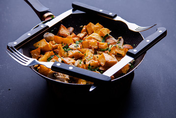 Fried meat in a frying pan closeup. Top view with copy space