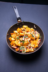 Fried meat in a frying pan closeup. Top view with copy space