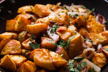 Fried meat in a frying pan closeup. Top view with copy space