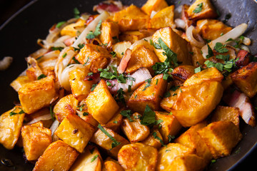 Fried meat in a frying pan closeup. Top view with copy space