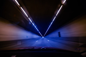 Driver POV at the long orange tunnel with end at the end