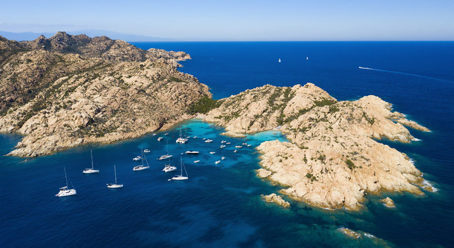 View from above, stunning aerial view of Cala Coticcio also known as Tahiti with boats and yachts floating on a turquoise clear water. La Maddalena Archipelago, Sardinia, Italy.