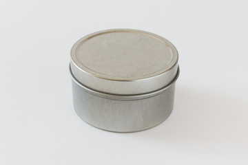 Mock up packaging round jar, tin can, with a cap made of brushed metal with empty blank surfaces for presentation text logo design on white background.