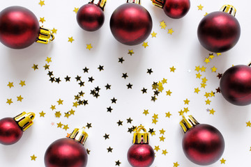 Festive Christmas New year background with many red balls and golden stars on white background.