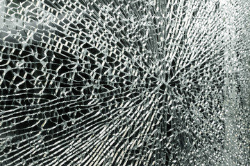 Texture structure of a broken glass with a center of hit smash bang on black background.