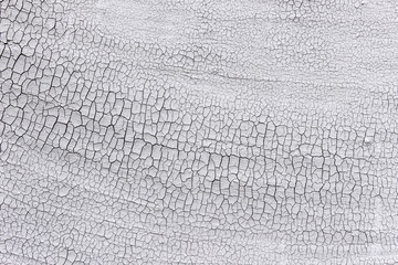 Texture of dry old weathered cracked surface covered with plaster. 