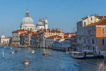 Fototapeta na wymiar Beautiful Venetian view with Grand Canal, Basilica Santa Maria della Salute and traditional gondolas, in Venice, Italy