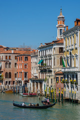 Fototapeta na wymiar Beautiful canal in Venice, Italy, with gondolas and historic houses, in a summer sunny day.