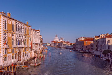 Fototapeta na wymiar Beautiful Venetian view with boats on Grand Canal and Basilica Santa Maria della Salute, in Venice, Italy.