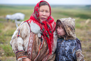 The extreme north, Yamal, the past of Nenets people, the dwelling of the peoples of the north, a family photo near the yurt in the tundra - obrazy, fototapety, plakaty